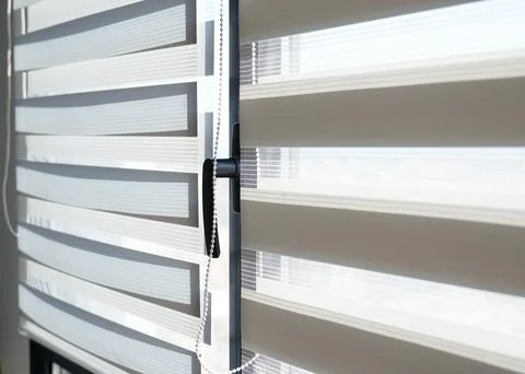 Modern striped window blinds with soft daylight filtering through fabric layers Foto stock