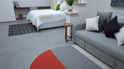 Modern studio apartment interior with contemporary furniture, bed, sofa, and Stock Footage 337263331