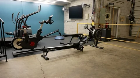 Modern studio gym with rowing machine and cardio training equipment Stock Footage 330627278