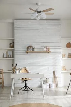 Modern studio interior with artist's workplace and art supplies Stock Photos