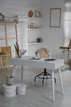 Modern studio interior with artist's workplace and art supplies 写真素材