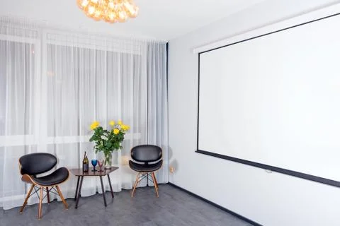 Modern studio interior with lights on. Projector screen. Contemporary interio Stock Photos