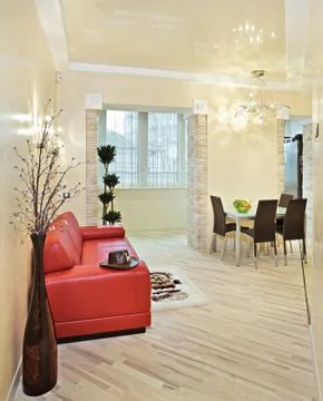 Modern studio interior with red sofa Stock Photos