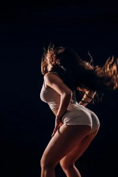 Modern style dancer jumping in studio on black background Stock Photos