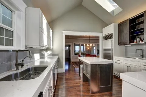 Modern style kitchen interior with brown and white cabinets, stainless steel  Stock Photos