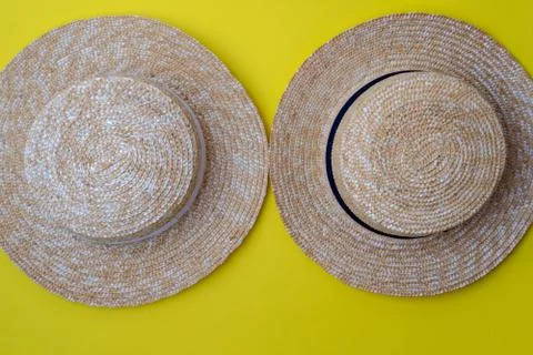 Modern stylish boater straw hats on a yellow background.Trip, travel and tour Fotos Stock