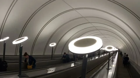 A modern subway escalator goes down. A lot of people go up and down. Beautiful Stock Footage 162463662