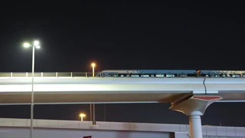Modern subway train arriving at an elevated station at night. Stock Footage 330933649