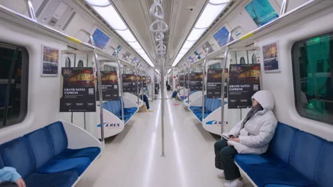 Modern subway train interior with blue seats and passengers during winter. 動画素材 338362862