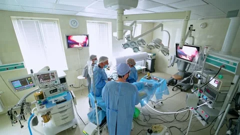 Modern surgery. Group of doctors wearing medical uniform in operating room Stock Footage 135886767