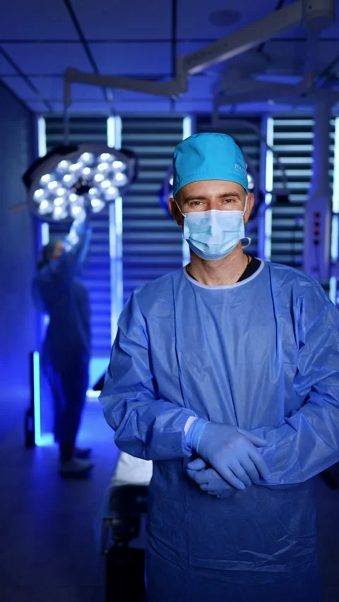 Modern surgery room with dim light and two medics in it. Video stock 312073082