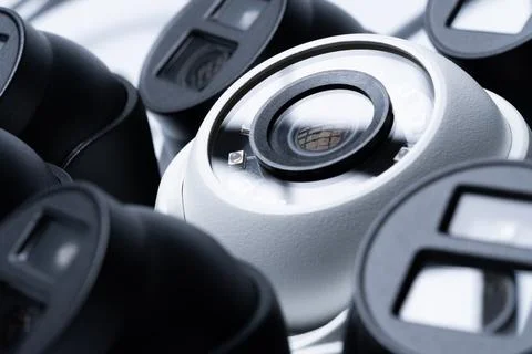 Modern surveillance camera on a light background, close-up. Stock Photos