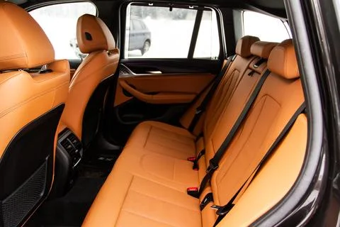 Modern SUV car inside. Leather light back passenger seats in modern luxury ca Stock-Fotos