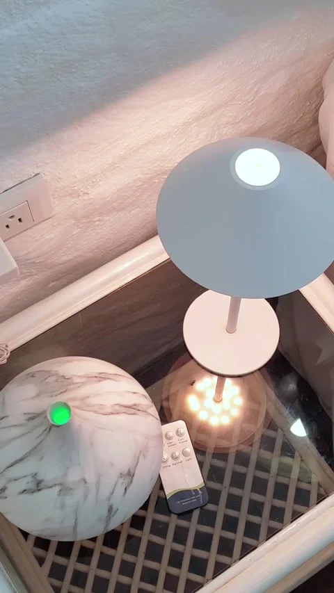 Modern table lamp and steaming marble-patterned diffuser, with a remote. Video stock 310199433