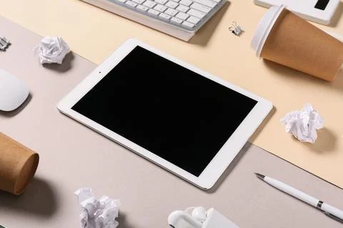 Modern tablet computer with blank screen, cup of coffee and crumpled paper on Stock Photos
