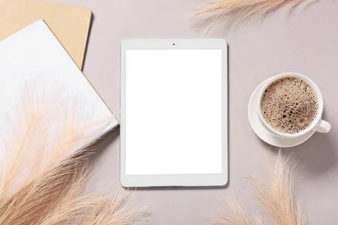 Modern tablet computer with blank screen, notebook and cup of coffee on grey  Stock Photos