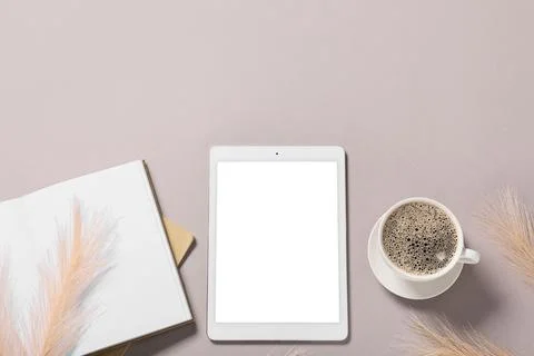 Modern tablet computer with blank screen, notebook and cup of coffee on grey  Stock Photos