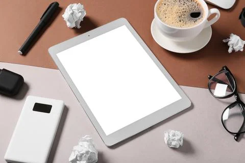 Modern tablet computer with blank screen, cup of coffee and crumpled paper on Stock Photos