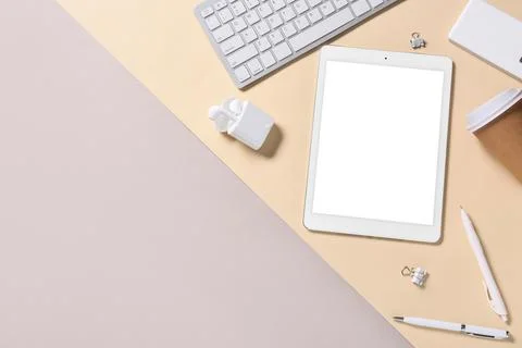 Modern tablet computer with blank screen, cup of coffee and earphones on colo Stock Photos