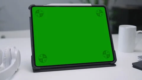 Modern Tablet Computer on White Desk with Blank Empty Green Mockup Screen Stock Footage 251136093