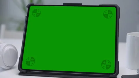 Modern Tablet Computer on White Desk with Blank Empty Green Mockup Screen Stock Footage 251525576