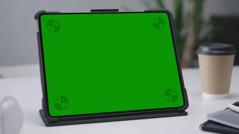 Modern Tablet Computer on White Desk with Blank Empty Green Mockup Screen Stock Footage 251731730