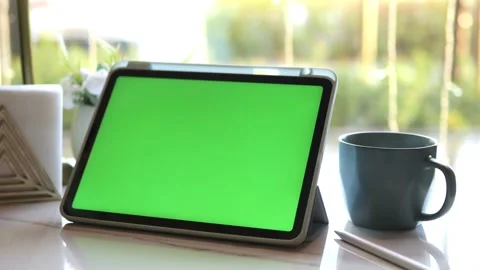 Modern tablet with green screen by window Stock Footage 340958965