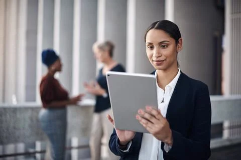 Modern tech making stacks of paperwork something of the past. a young 写真素材
