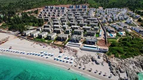 Modern tech villas right on the seafront with their own beach. Flying over a Stock-Footage 157473317
