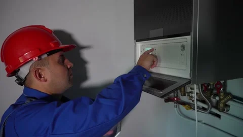 Modern technician man setting heating system settings with tablet computer Stock Footage 153314749