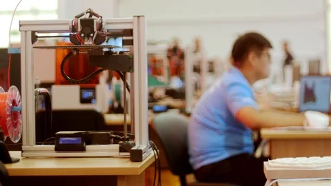 Modern technological exhibition - a man worker fixes computer - 3D printer in Stock Footage 115651027