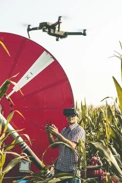 Modern technological farmer analyzing the growth of corn by flying a drone Stock Photos