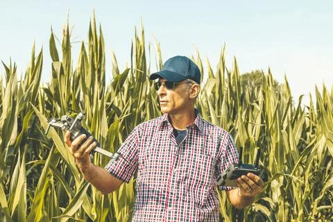 Modern technological farmer as he prepares to fly the drone over his cultiv.. Stock Photos