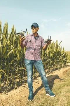 Modern technological farmer as he prepares to fly the drone over his cultiv.. Stock Photos