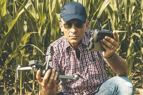 Modern technological farmer as he prepares to fly the drone over his cultiv.. Stock Photos