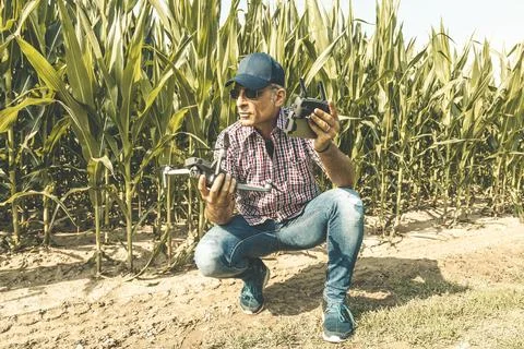 Modern technological farmer as he prepares to fly the drone over his cultiv.. Stock Photos