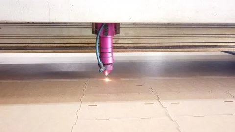Modern Technological Industrial laser Cnc while cutting a pattern on a Stock Footage 153583172