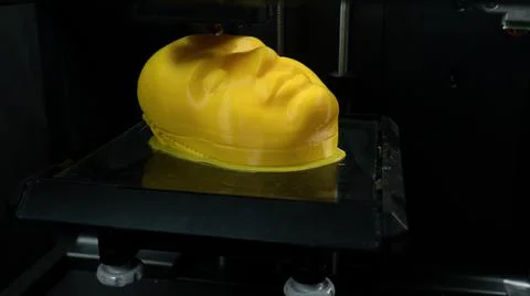 Modern technologies, 3d printer prints the yellow model of the head, the process Fotos Stock