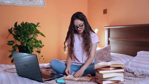 Modern technologies and education, studying at home with books and laptop Stock Footage 133446350