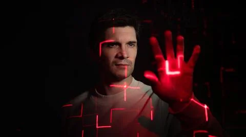 Modern technologies and human. young man with projection of red lines Stock Photos