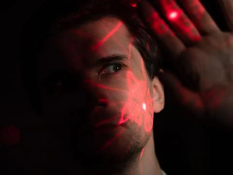 Modern technologies and human. young man with projection of red lines Stock Photos