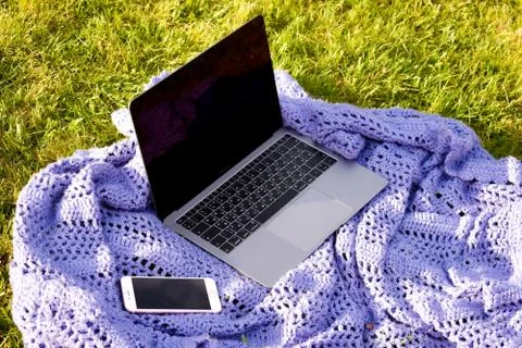 Modern technologies for remote work. computer and smartphone on grass in garden Stock Photos