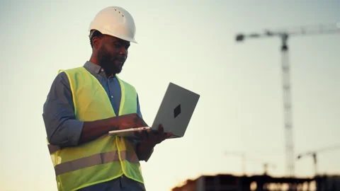 Modern technology and software for architect and builders, black man with laptop Stock Footage 318343346