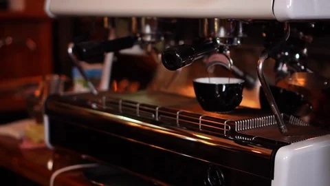 Modern technology coffee machine making espresso in small black cappuccino cup Stock Footage 104514178