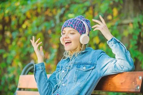 Modern technology instead of reading. listening music in park. hipster woman in Stock Photos