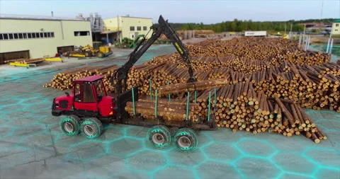 Modern technology at the sawmill. Auto with a manipulator arm loads logs. Modern Stock Footage 238076979