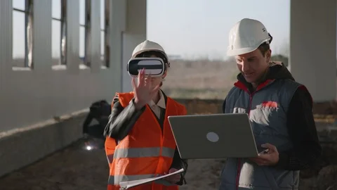Modern technology, woman engineer in protective helmet and viar glasses looks at Vidéo 129710982