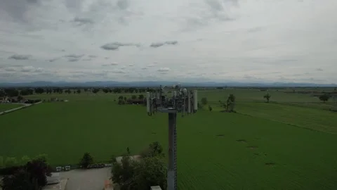 Modern telecommunications infrastructure stands tall in the flat, green lan.. Stock Footage 327601821