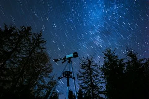Modern telescope and beautiful sky in night outdoors, low angle view. Star .. Stock Photos