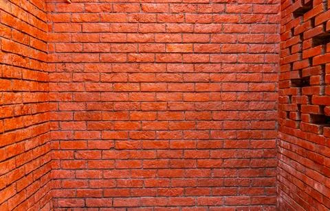 Modern textured red brick wall corner with decorative screen pattern Stock Photos